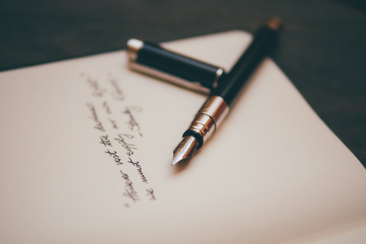 Fountain pen resting on a handwritten page