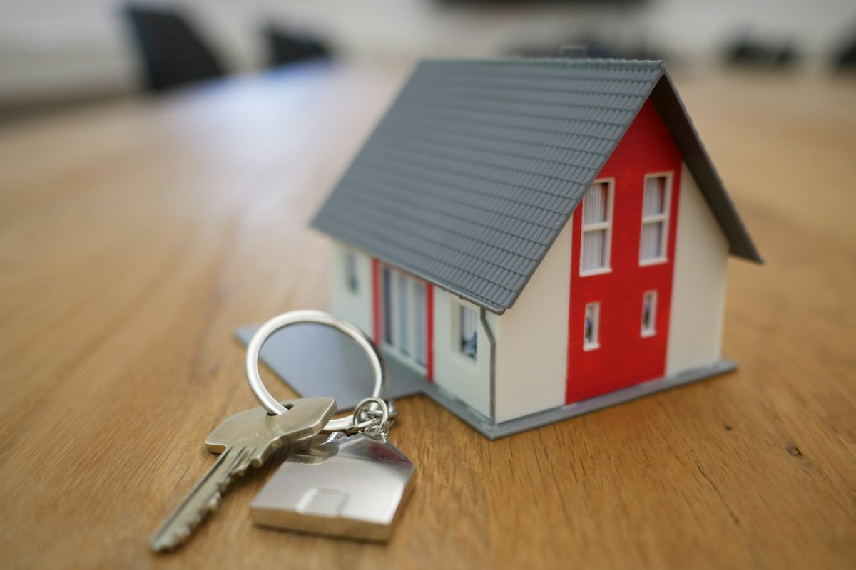 Small house model with a set of keys on a table