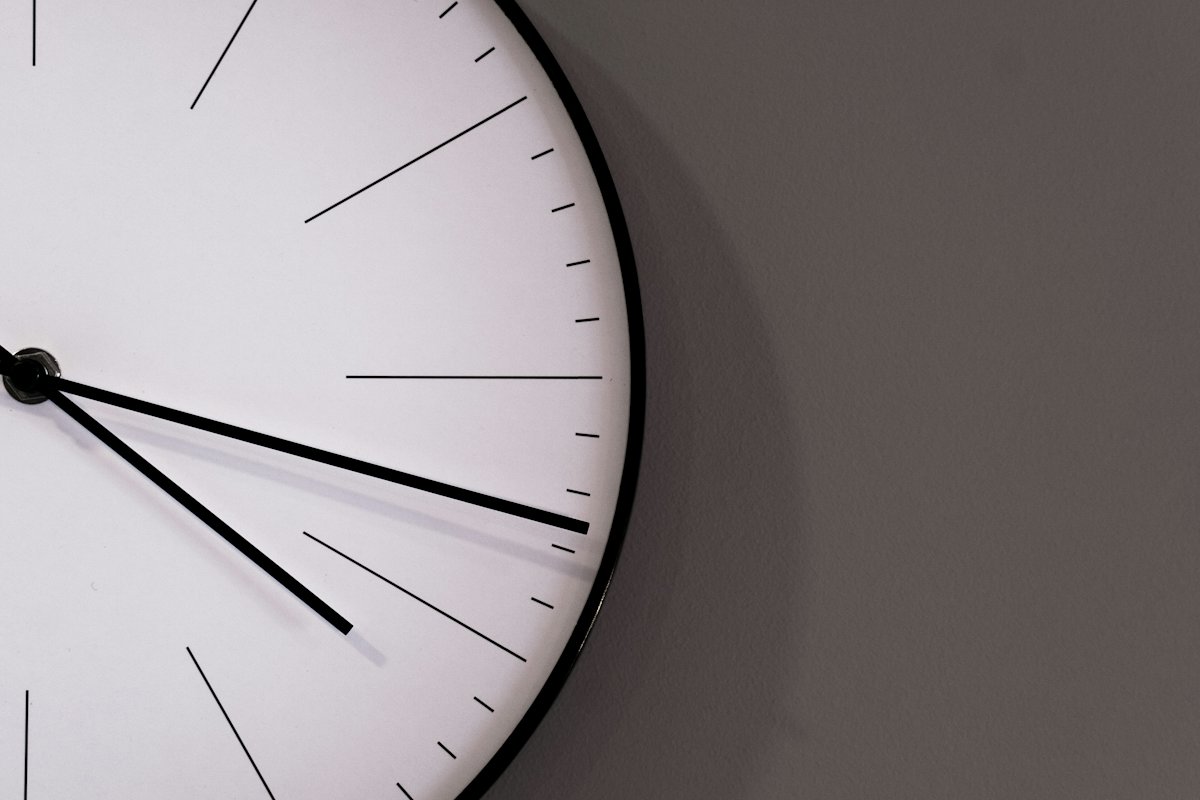 Close-up of a minimal white wall clock