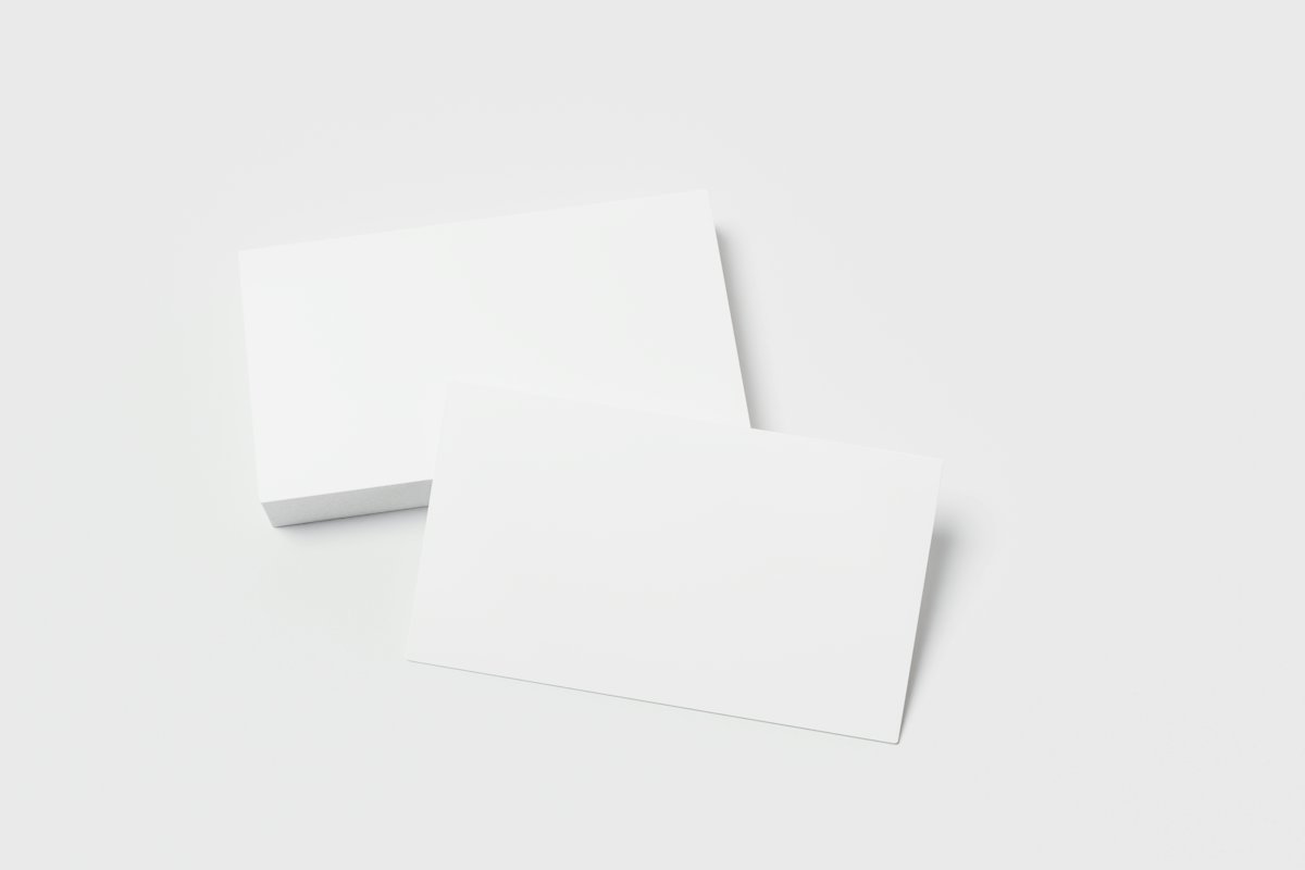 Two blank white cards on a light grey surface