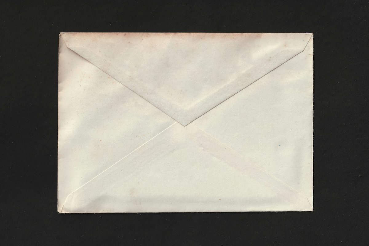 Plain white envelope on a dark background